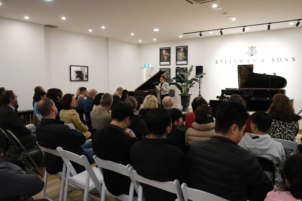 Sale Manager June O'Connor welcoming the audience at Steinway Gallery Melbourne for the concert night.