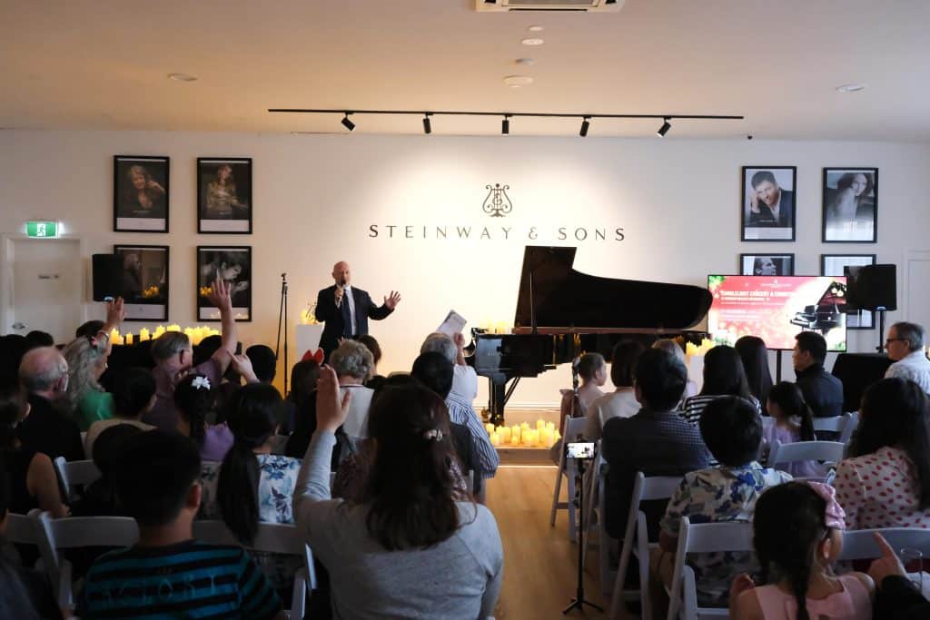 CEO Mark O'Connor welcoming the audience at Steinway Gallery Melbourne for the Christmas Candlelight Concert.